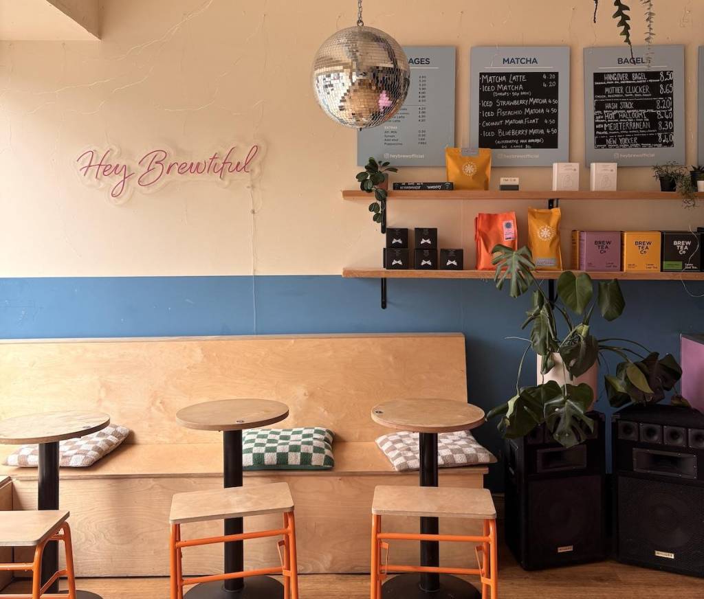 a cafe with wooden bench seating and a disco ball 