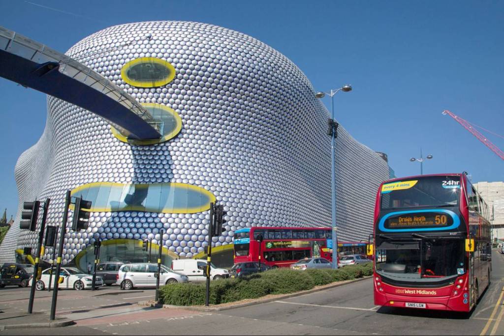 Birmingham, UK: June 29, 2018: Street view of Selfridges Department Store in Park Street - part of the Bullring Shopping Centre. a bus is stopped at the traffic lights.