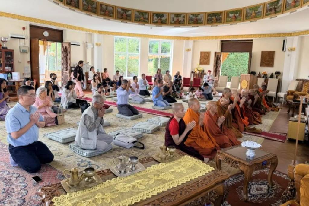 Buddhists praying inside Dhamma Talaka Peace Pagoda, Ladywood, Birmingham