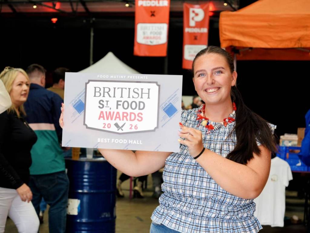 British Street Food Awards sign held up by Nina, COO of Blend Family