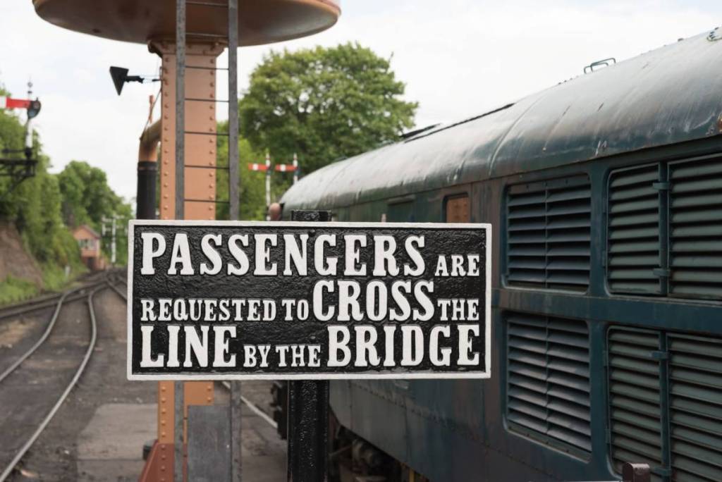 Bewdley, England May 20 2016 - Vintage sign warns passengers not to cross railway line