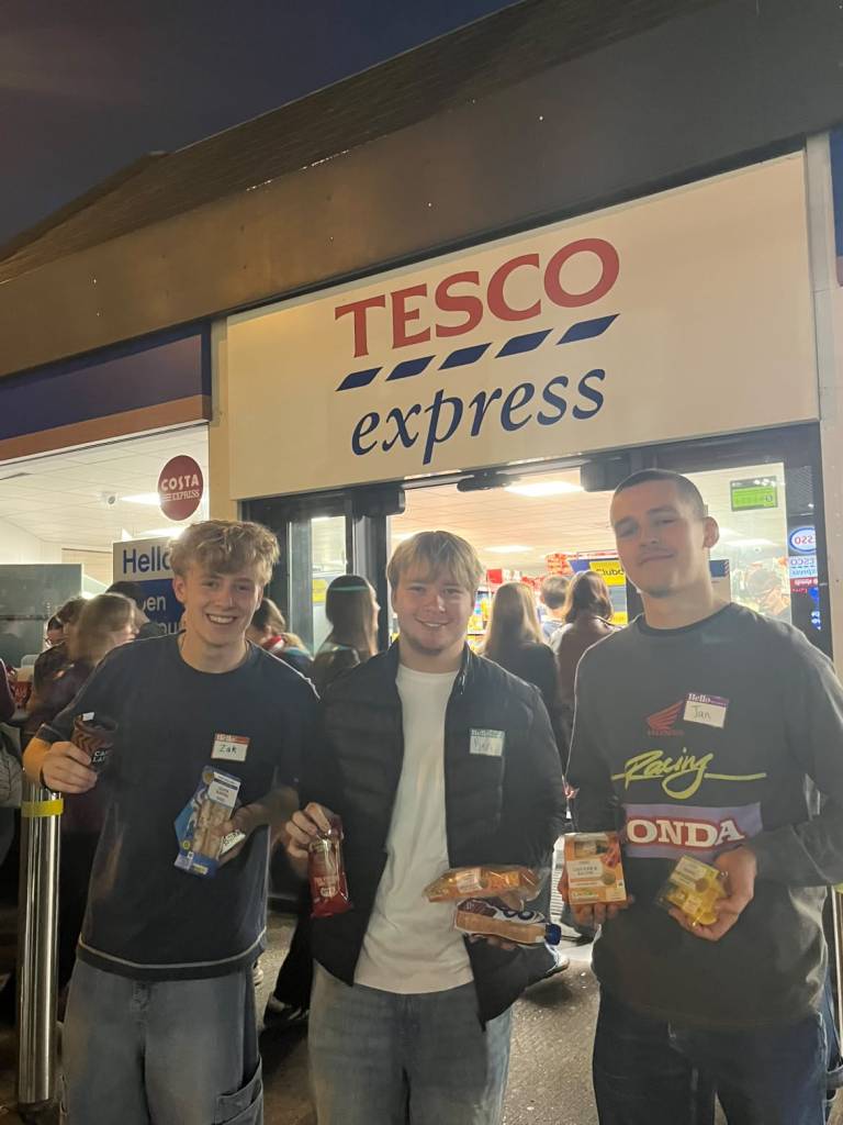 Three students from the Meal Deal Society at University of Birmingham outside a Tesco Express