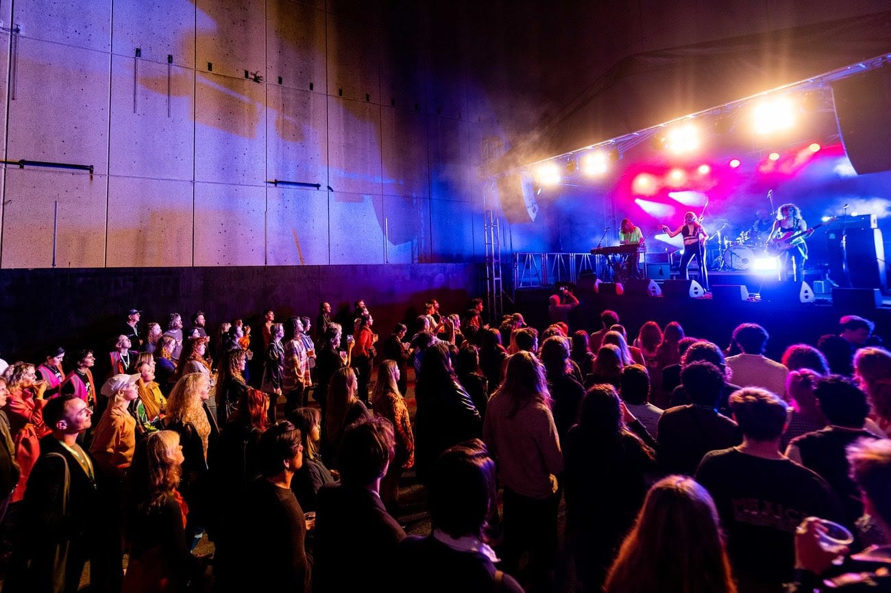 a photo of a band performing in front of a crowd