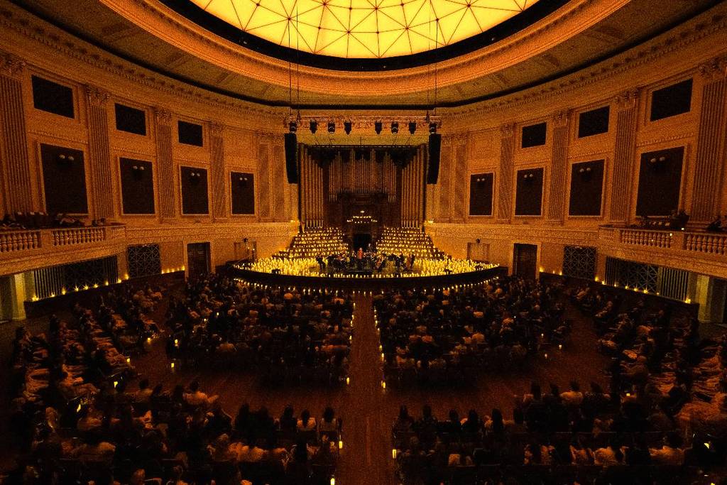 Candlelight Orchestra performing inside Brisbane City Hall amid thousands of candles