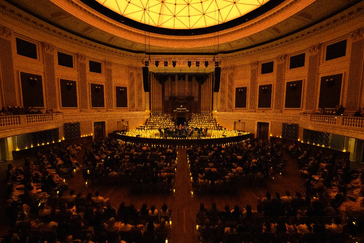 Candlelight Orchestra performing inside Brisbane City Hall amid thousands of candles