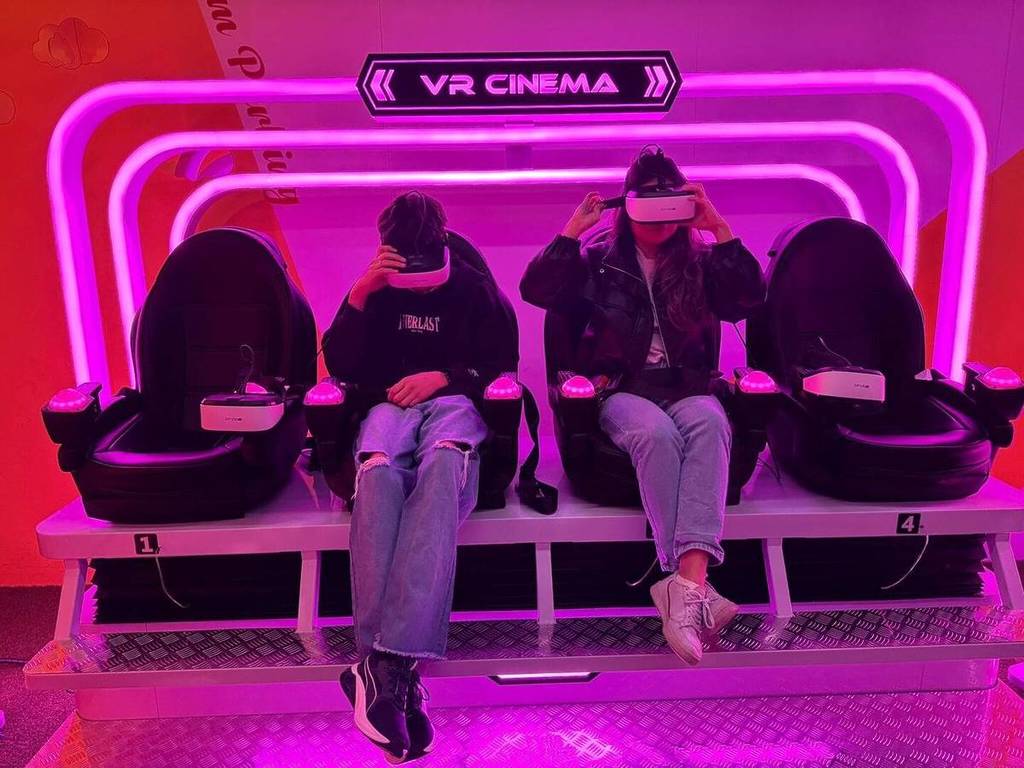 A young girl and boy enjoy a VR experience at Dopamine Land.