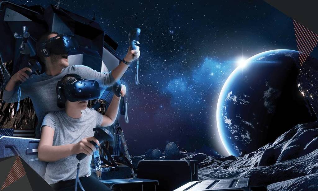 A man and a woman are pictured in VR headsets holding game controllers. Behind them is a long-distance shot of space and a planet, one of the experiences available at Virtual Room.