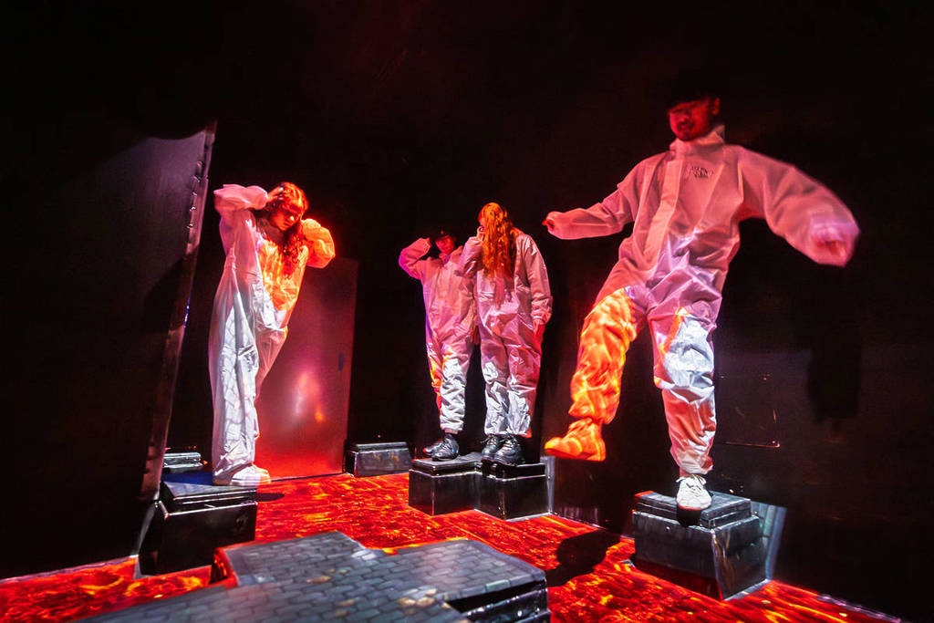 Four people in white hazmat suits play a game similar to "the floor is lava" at 123Boom!