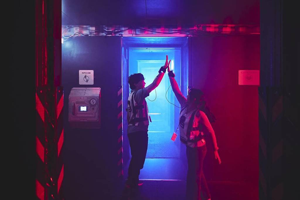 Two friends high-five at Saboteurs.