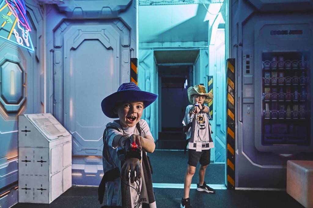 Two young boys point their laser-beam shooters at the camera at Saboteurs.