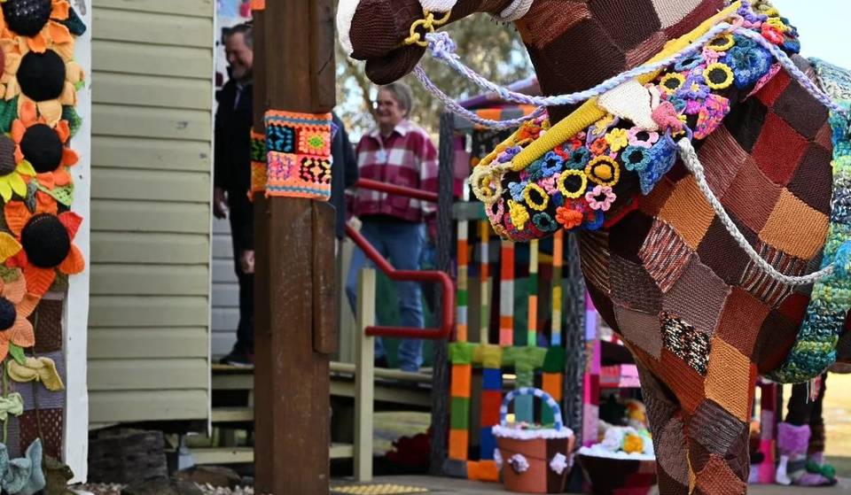 This charming town is transforming into a fuzzy winter wonderland with a whimsical underwater scene made entirely from yarn