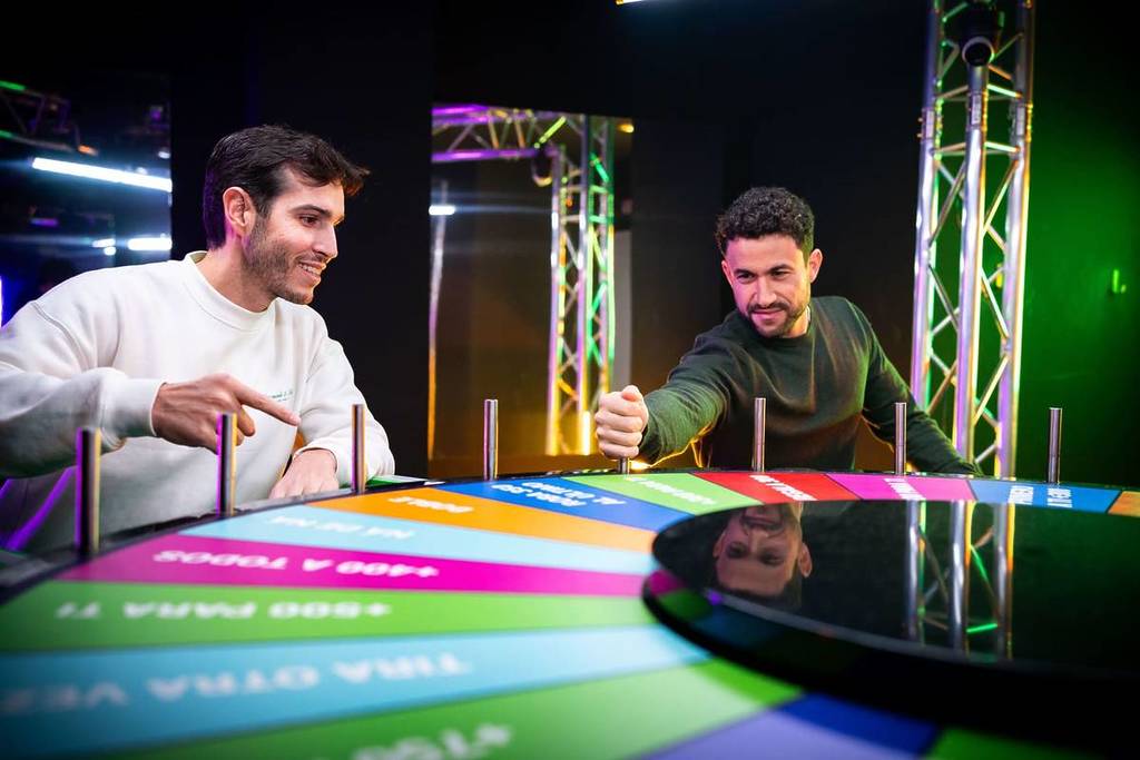 Two guys spin the wheel at BuzzAttack.