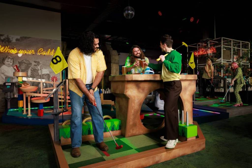 Friends play mini-golf at Funlab's Day of Fun.