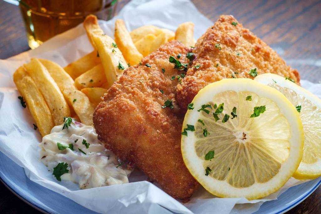 Authentic traditional British cuisine fish and chips served with an ice cold beer in Bristol