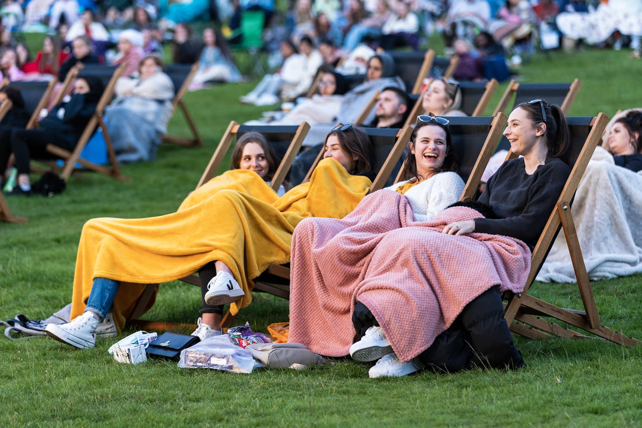 Four women watching an outdoor cinema screening