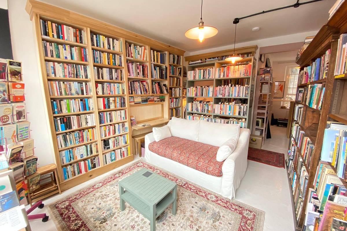 Inside Dreadnought Books with a sofa surrounded by bookshelves