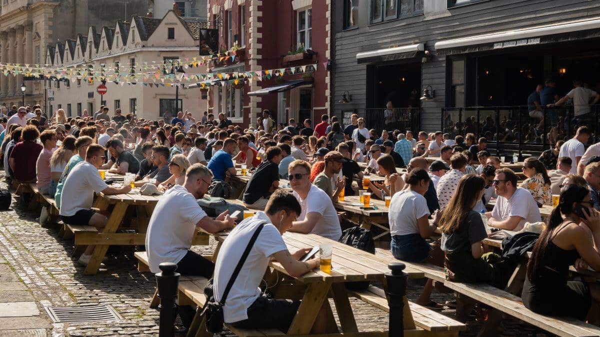 People drinking at outdoor seating on King Street in Bristol City Centre