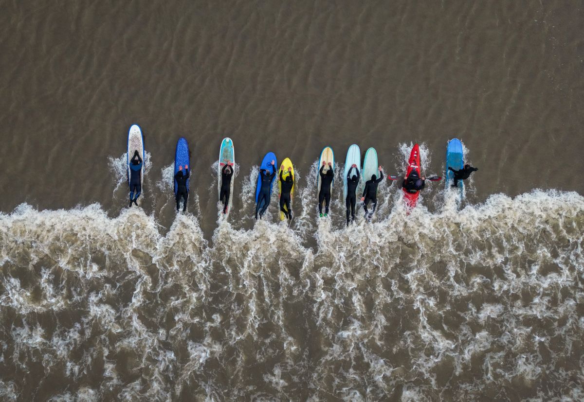 GLOUCESTER, ENGLAND - MARCH 22: Surfers and Kayakers ride The Severn Bore wave on March 22, 2023 in Gloucester, England. Occurring just a few times per year, The Severn Bore is a natural phenomenon caused by a rising tide, creating a series of waves on the River Severn that can be ridden by surfers, kayakers and paddleboarders. (Photo by Ryan Pierse/Getty Images)
