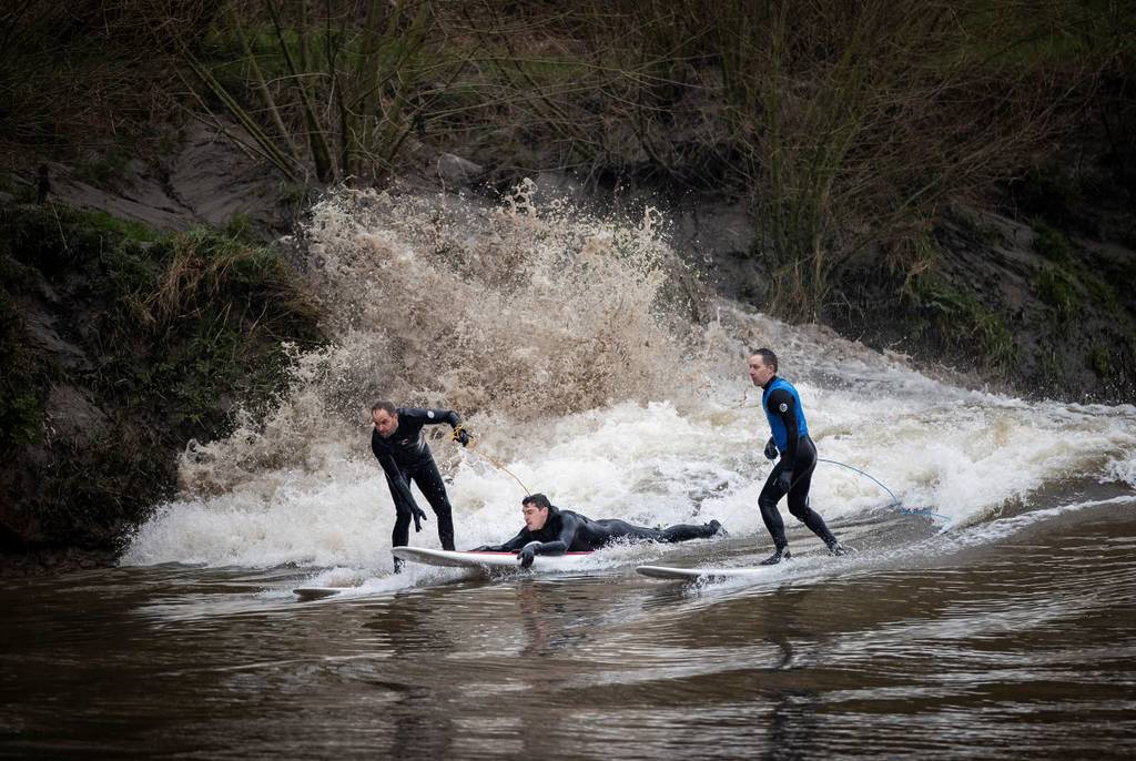 GLOUCESTER, ENGLAND - MARCH 11: Surfers Ben Dennis and Ric Clarke ride The Severn Bore WaveSurfers ride The Severn Bore wave on March 11, 2024 in Gloucester, England. Occurring just a few times per year, The Severn Bore is a natural phenomenon caused by a rising tide, creating a series of waves on the River Severn that can be ridden by surfers, kayakers and paddleboarders. (Photo by Ryan Pierse/Getty Images)