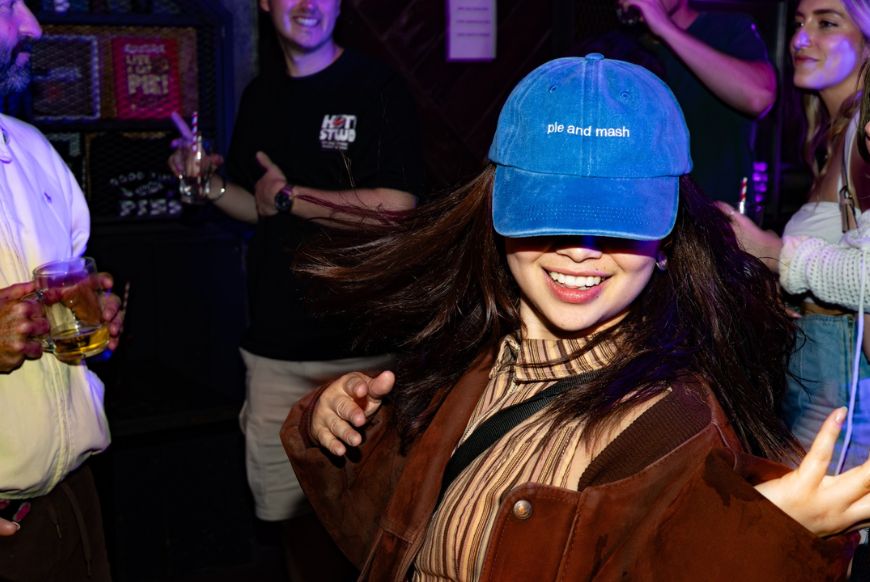Pieminister party: A Woman wearing a cap that reads 'Pie and mash'