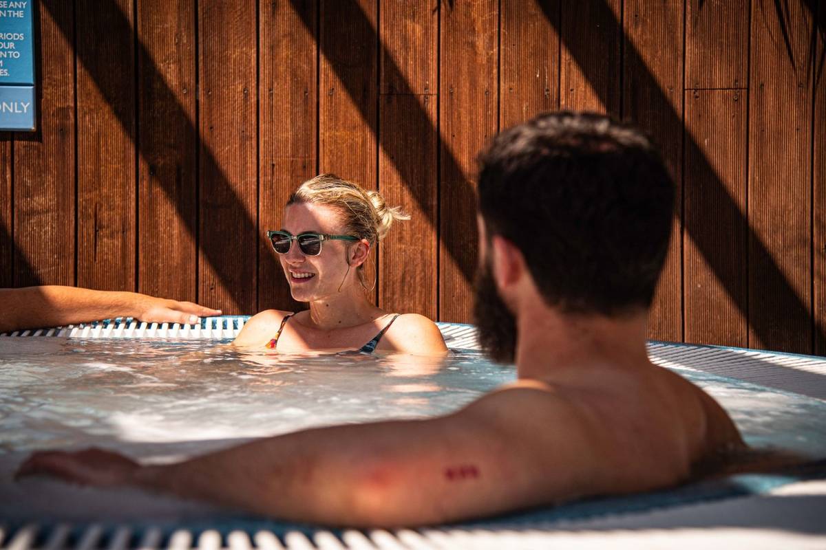 A woman and a man in a hot tub