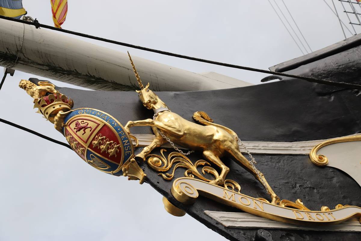 Bristol, England, UK: August 2018 -Exterior view of Brunel's SS Great Britain, A Museum Ship in Bristol Harbour, a close up of golden unicorn statue