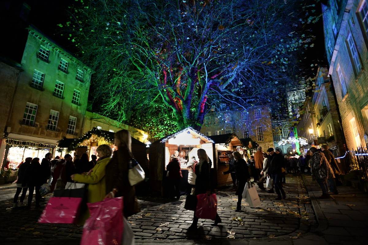 BATH - NOV 30: People visit the Christmas Market in the streets surrounding Bath Abbey on Nov 30, 2014 in Bath, UK. The market has become an annual fixture for the historic Unesco World Heritage City.
