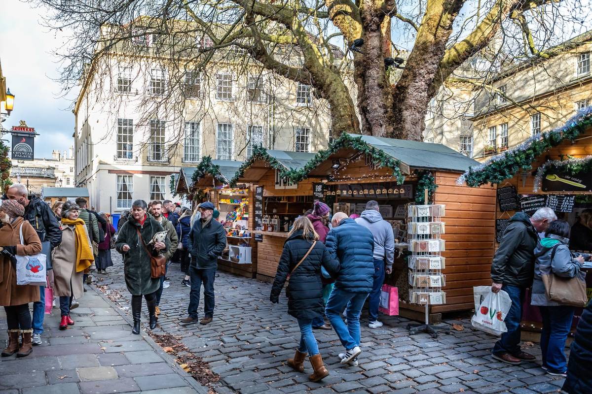 Market stalls at Bath Christmas Market in Abbey Green, Bath, Somerset, UK on 13 December 2019