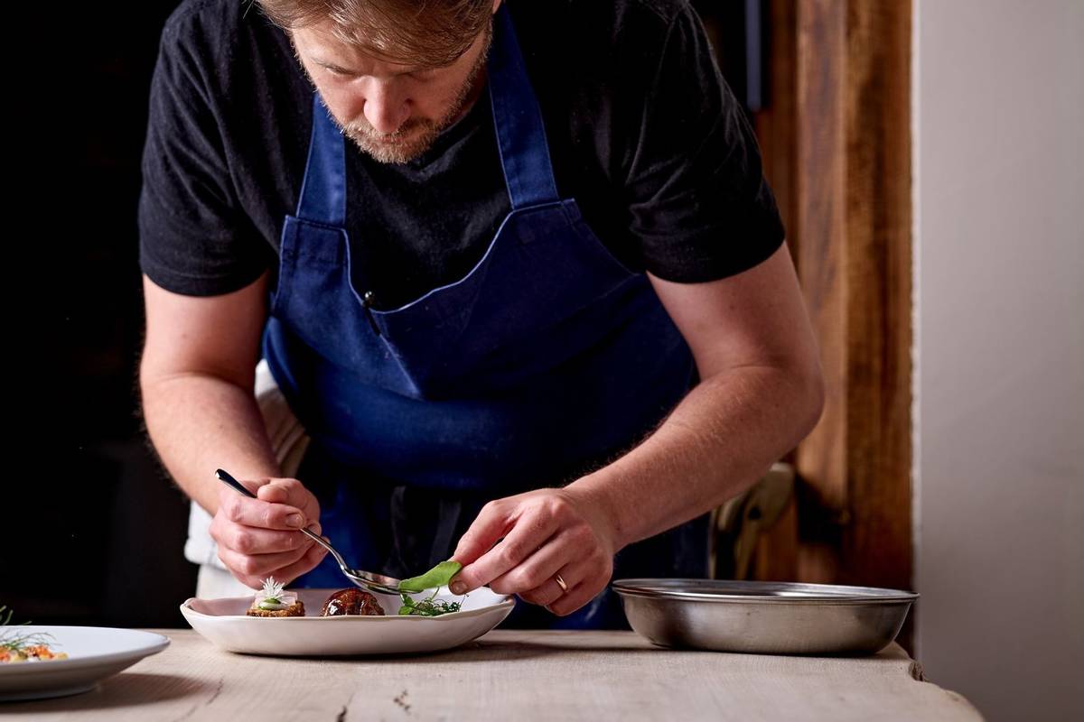 A chef plating food at the Barrington Boar