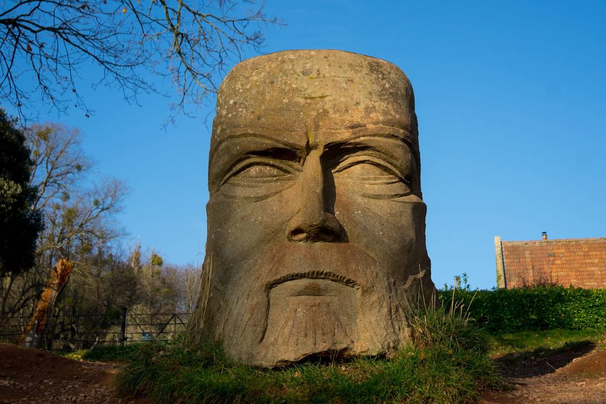 Bristol, UK - November 18 2018: Huge Goram the Giant stone carving at Ashton Court, Bristol, UK on bright blue sky sunny day