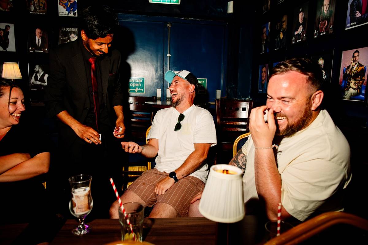 A performer doing table magic at Smoke & Mirrors