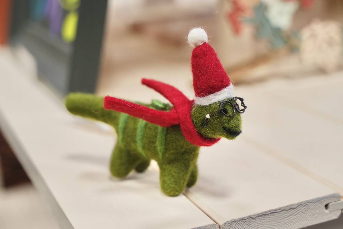 A felt Christmas dinosaur