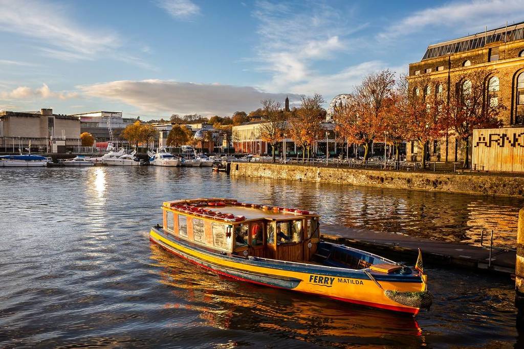 Ferry and autumn colours in Bristol Harbour in Bristol, Avon, UK taken on 7 November 2018