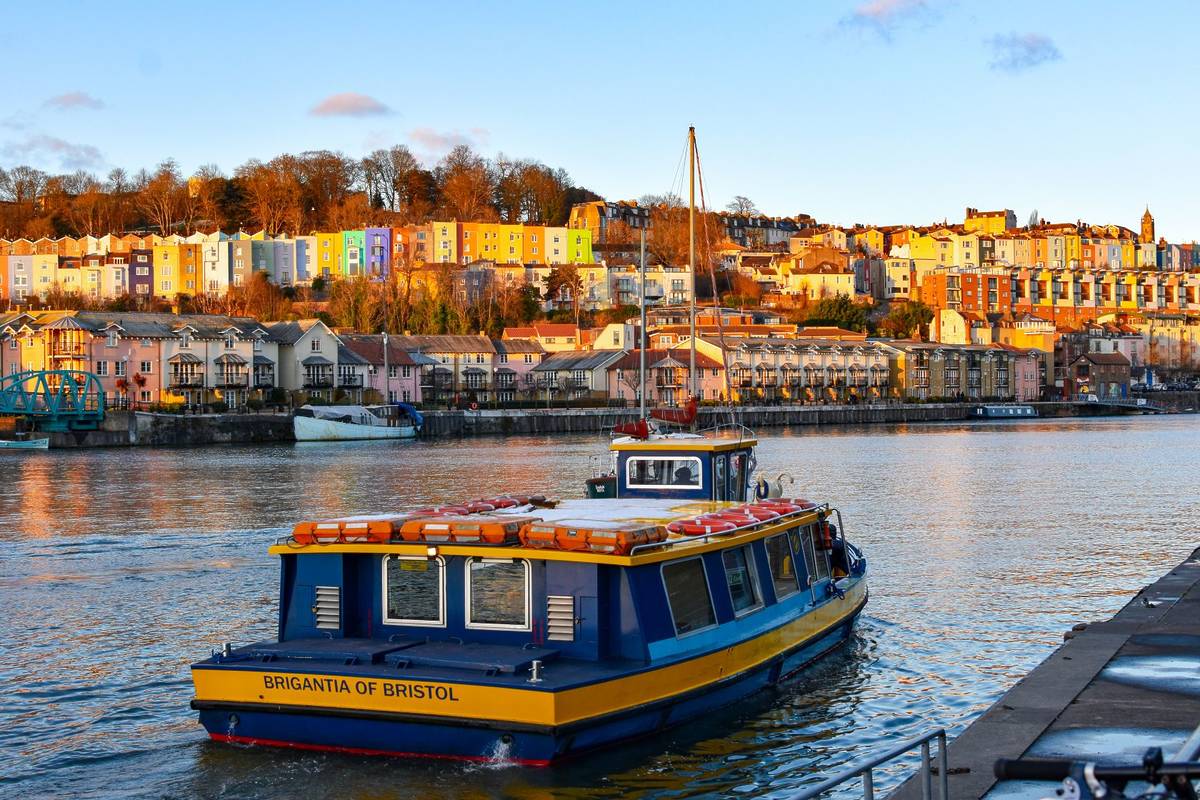 Bristol, UK - February 2019: The ferry boat Brigantia of Bristol passes the colorful buildings in the Hotwells area of Bristol, England -Image