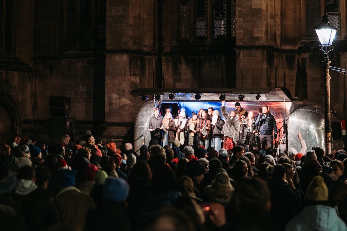 A crowd of carol singers outside Bristol cathedral
