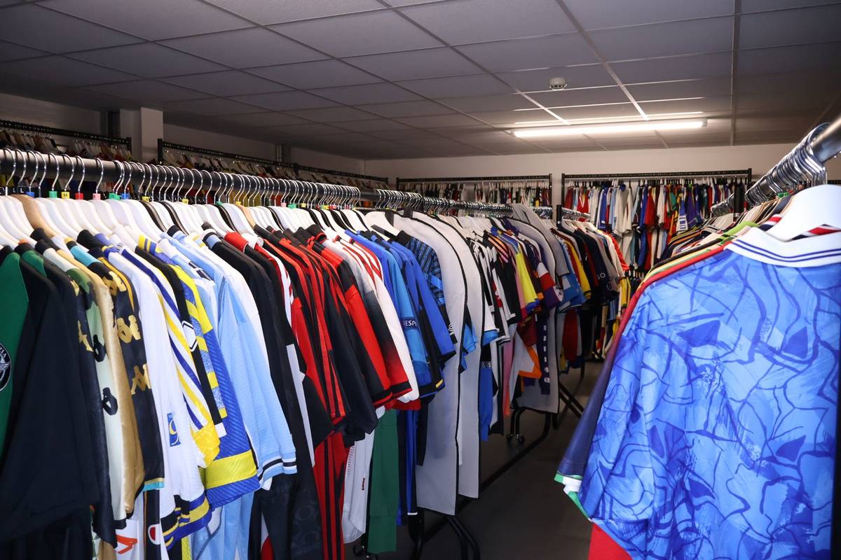 A collection of football shirts on rails at TopBinz Football Shirts
