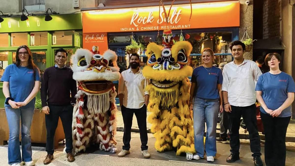 RockSalt team stood with traditional lion costumes outside restaurant for Lunar New Year