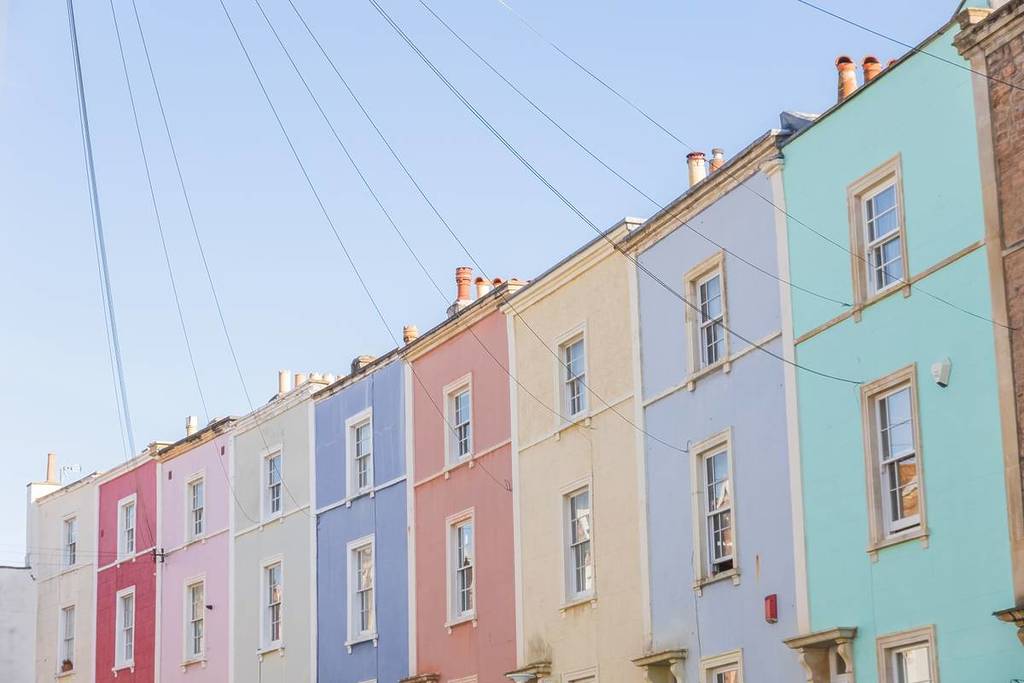 Row of pastel coloured terraced houses in Cliftonwood, Bristol, England