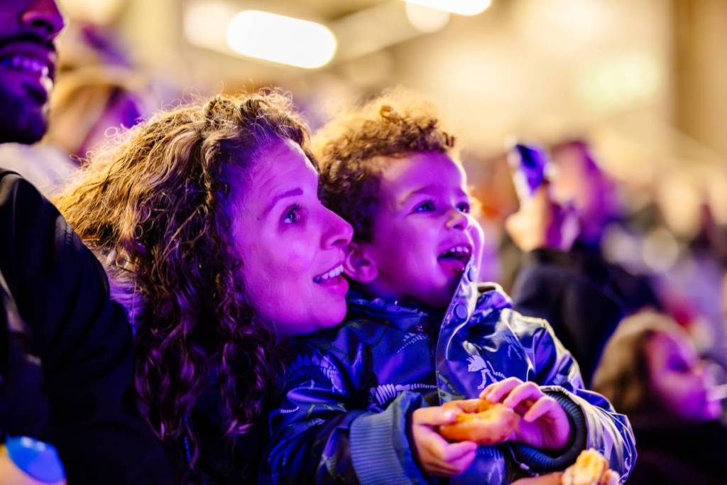 child and parent watching the drone light show 