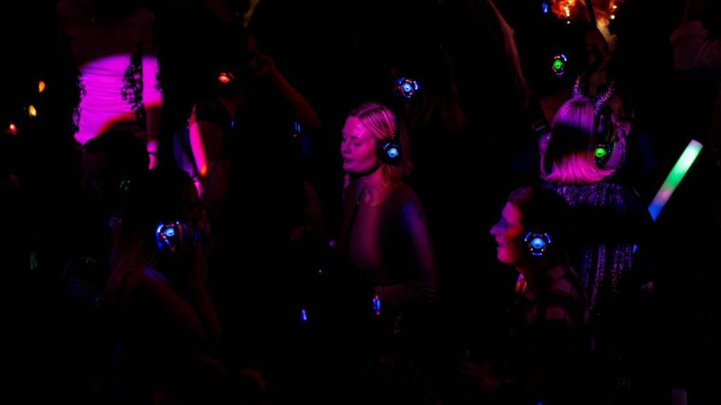an image focused on a dancer enjoying the music in her headphones at a silent disco