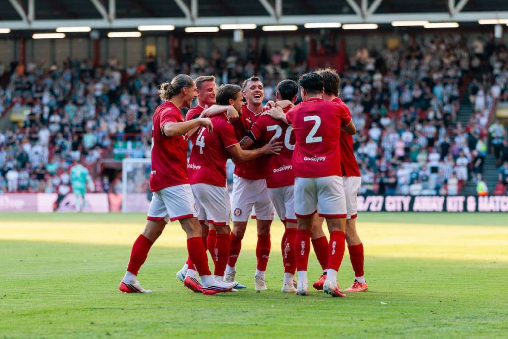 bristol city players hugging on the pitch