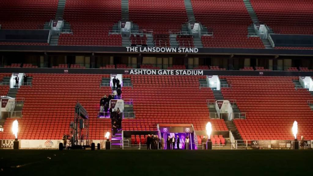 a wide shot of the stands of Ashton gate stadium with a party happening inside the concourse