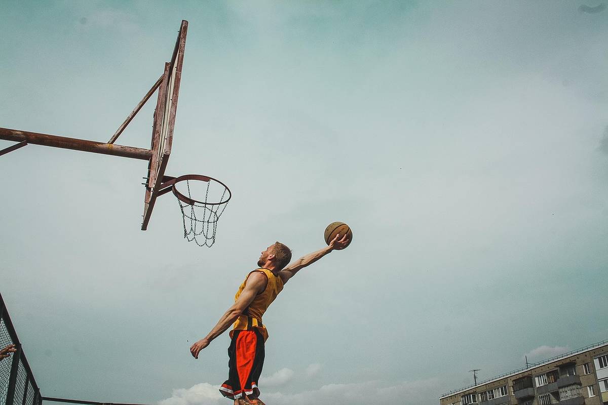 Basketball player throwing ball into the hoop