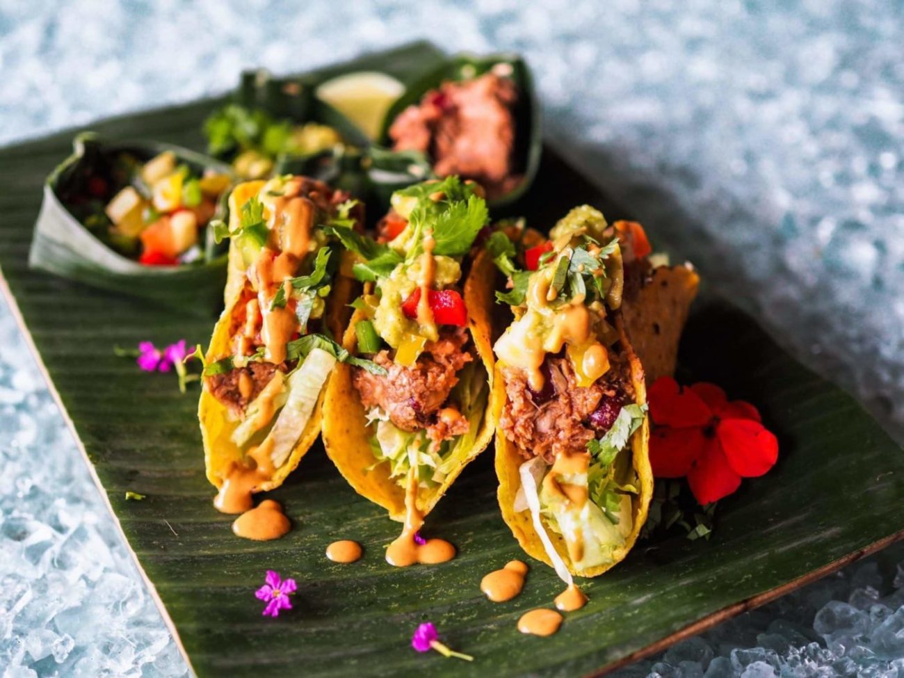 three vegan jackfruit tacos on a platter