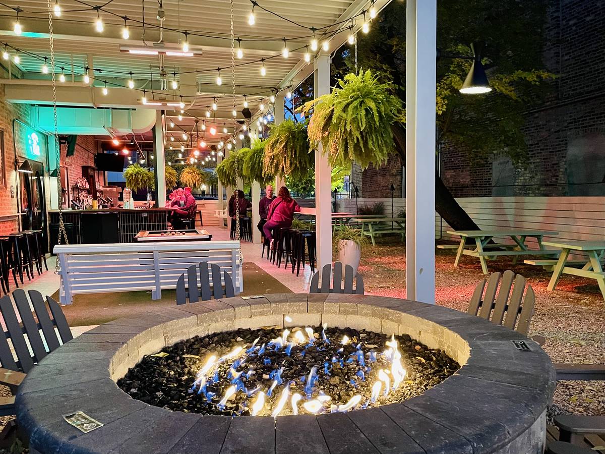 twinkling lights, suspended verdant plants, and countless picnic tables at central park bar