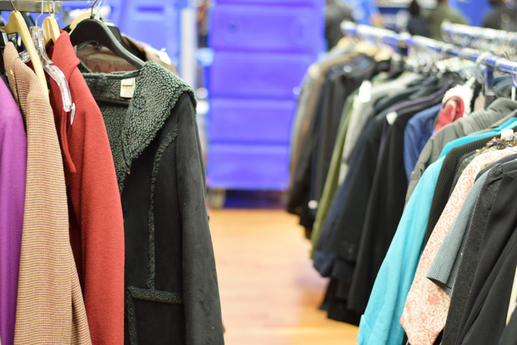 Racks of stylish used clothing at a thrift shop