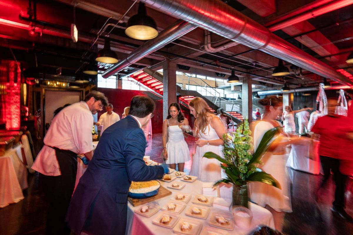 Guests enjoying food at the Chicago Fire White Party