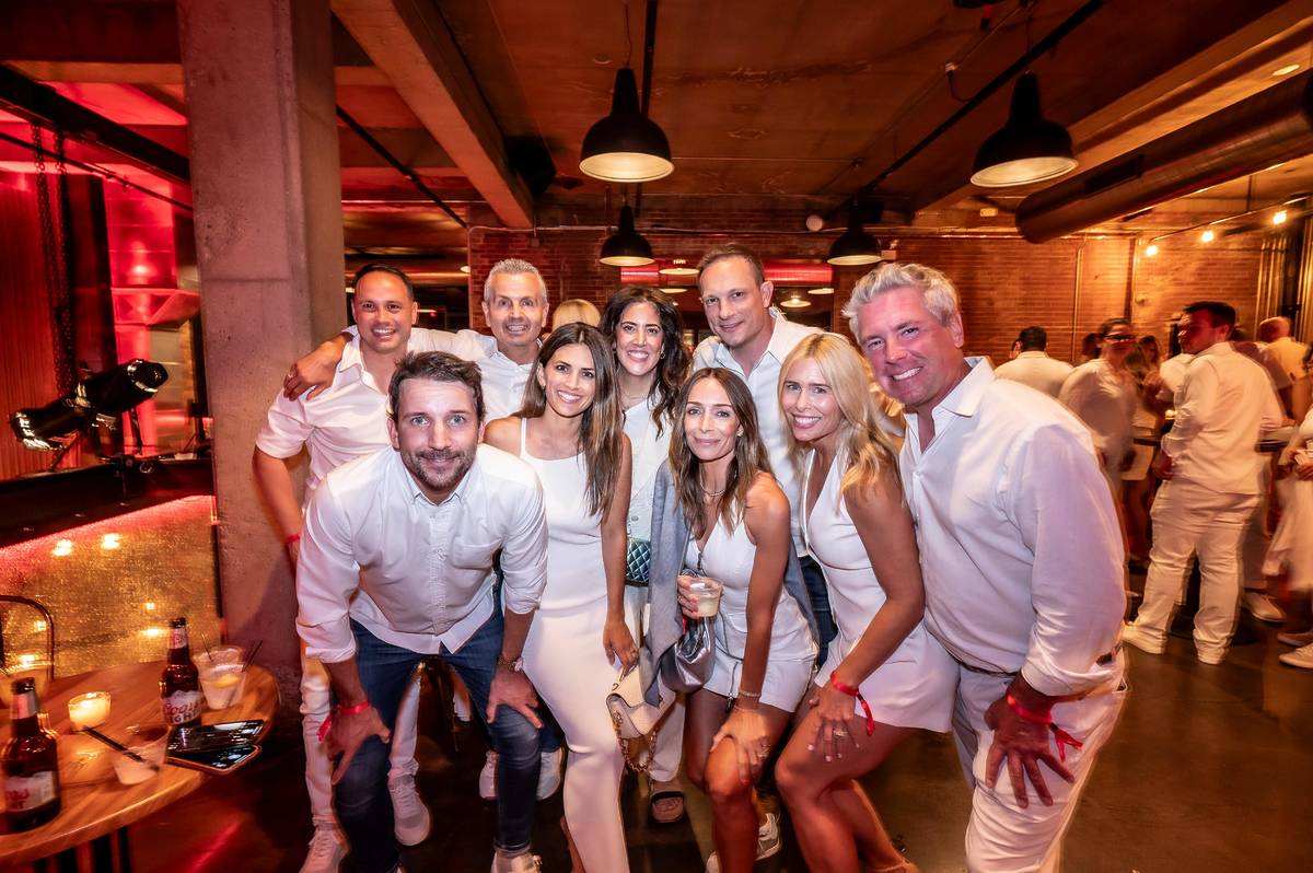 a group of friends pose at the Chicago Fire White Party