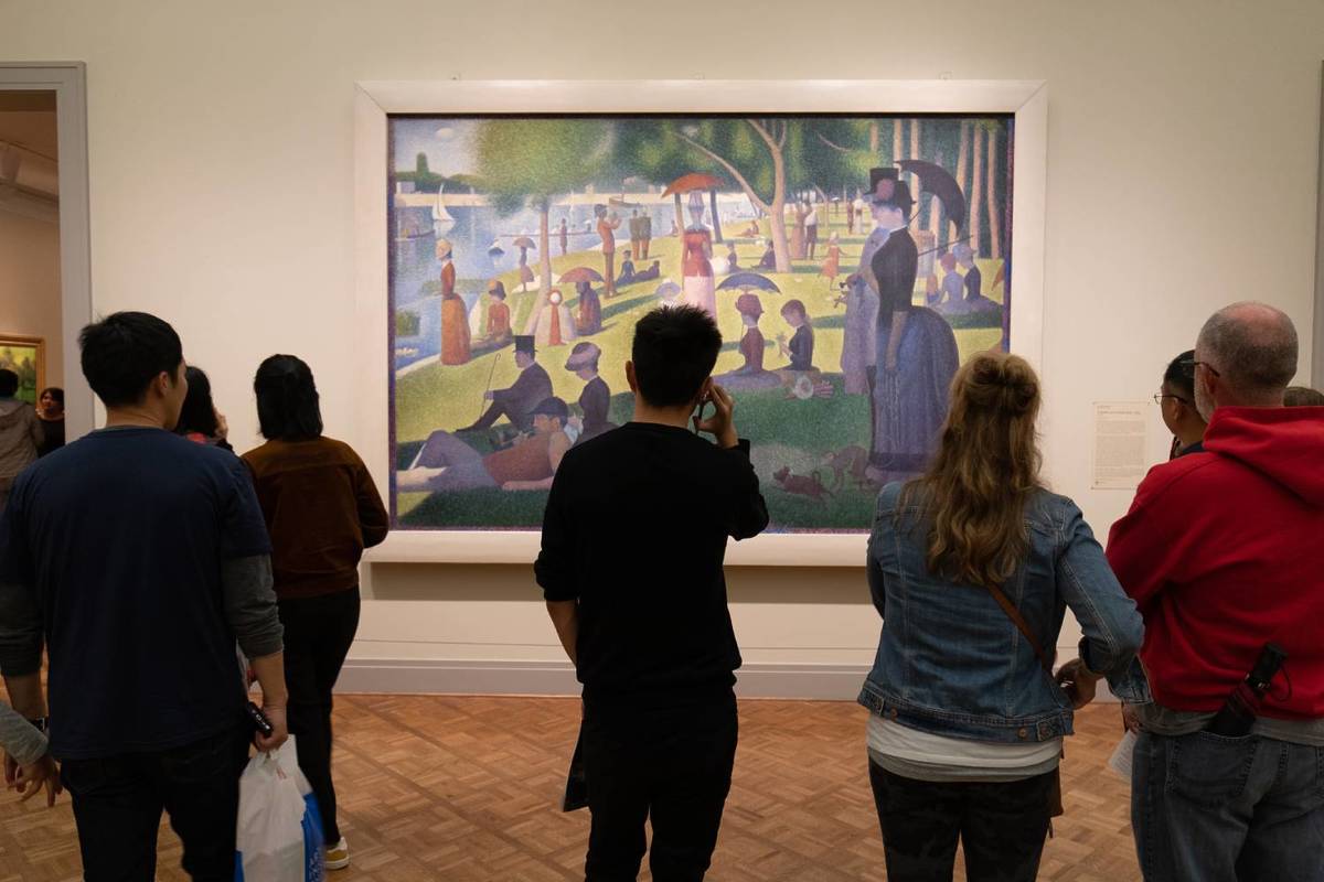 People looking at a painting at the Art Institute of Chicago