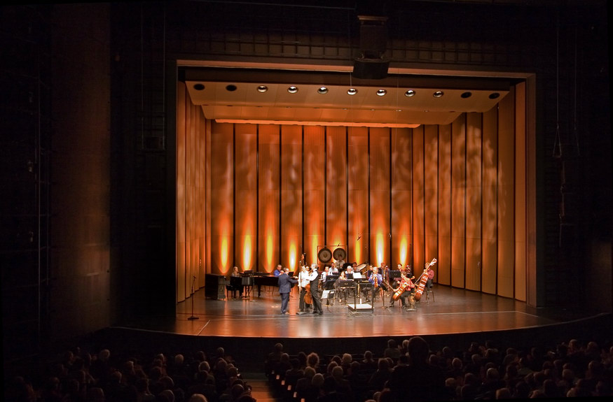 The stage At Harris Theater, illuminated with red lighting.